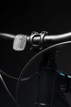 Close up photo of a bicycle against black background