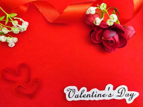 Valentine's Day concept celebration, congratulation. Red greeting Card with flower, Satin ribbon for Background, texture, place for text, copy space