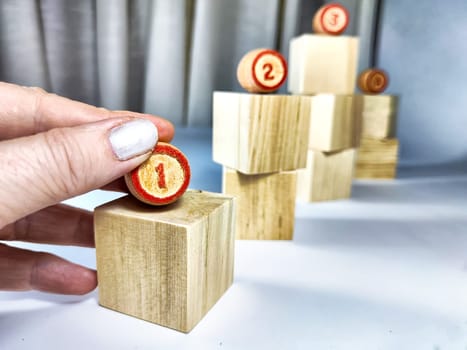 Small wooden cubes in columns, lined up in row and with numbers. Concept of stages of achieving goal. The need for the first step for the successful development and implementation of the project