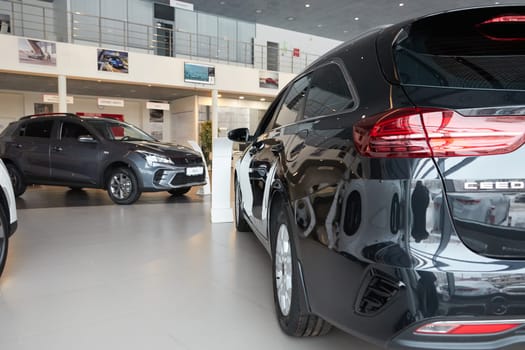 Kazan, Russia - November 25, 2022: Cars in showroom of dealership Kia in Kazan in Russia. Partial focus