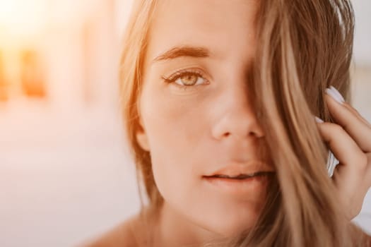 Happy woman portrait in cafe. Boho chic fashion style. Outdoor photo of young happy woman with long hair, sunny weather outdoors sitting in modern cafe