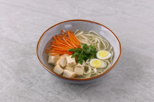 Chicken soup with homemade noodles on a white background studio shot 3