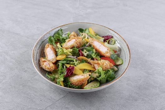bowl with shrimp in batter, avocado and kumquat on a stone background, studio food photography 1