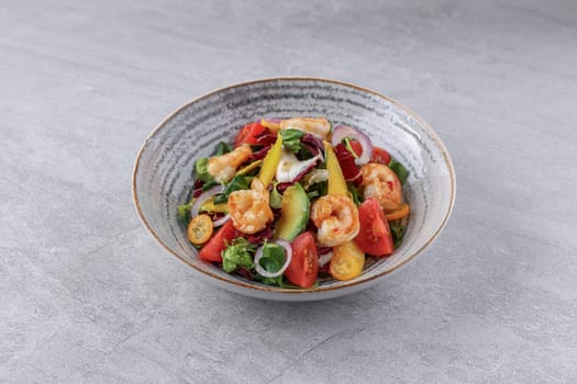bowl with avocado shrimp and kumquat on stone background, studio food photography