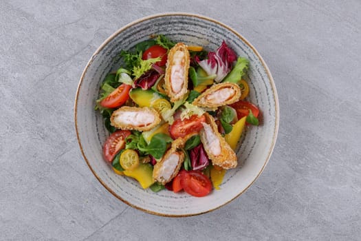 bowl with shrimp in batter, avocado and kumquat on a stone background, studio food photography
