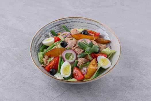 salad with tuna, quail eggs and baked potatoes on a stone background, studio food photography 3