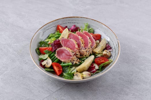 salad with carpaccio, artichoke and asparagus on a stone background, studio food photography 1