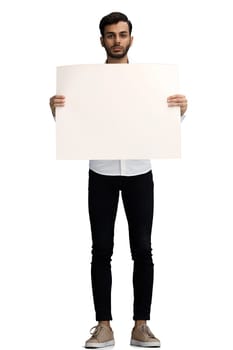 man on a white background in full growth holding a white sheet of paper copy spice.