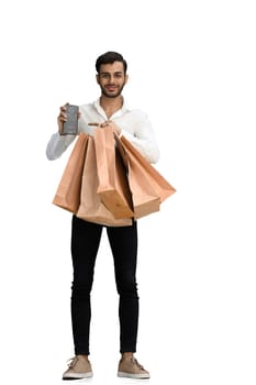 Man on a white background with shoppers and phone.
