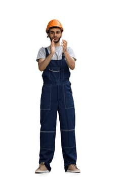 A builder male on a white background claps in hand.