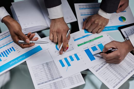 close-up. business colleagues look at the graph on the table from above