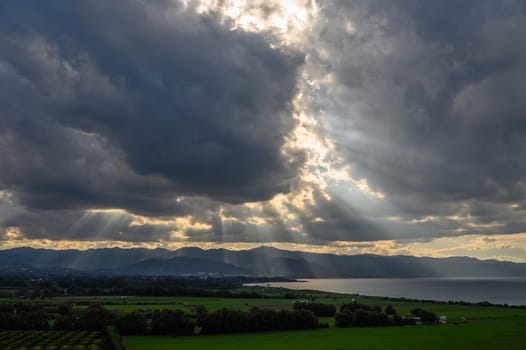 sun rays through dramatic clouds over mountains and sea in cyprus 5