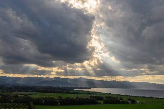 sun rays through dramatic clouds over mountains and sea in cyprus 4