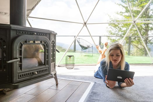 Young woman holding the tablet and sitting at home