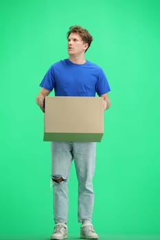 The deliveryman, full-length, on a green background, with a box.