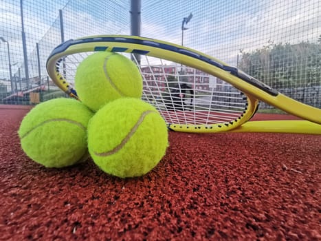 tennis racket with a tennis ball on a tennis court. High quality photo