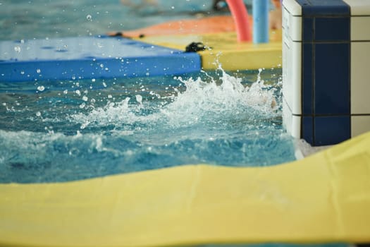 Children playing in the pool Splashes from jumping