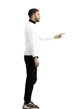 A man, full-length, on a white background, points to the side.