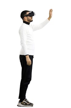 Man, full-length, on a white background, wearing VR glasses.