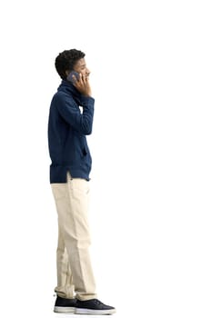 A man, full-length, on a white background, talking on the phone.