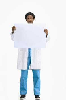 The doctor, in full height, on a white background, shows a white sheet.
