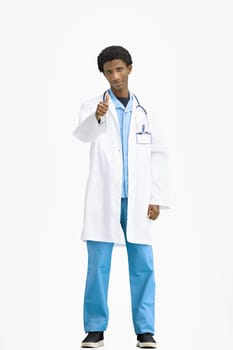 The doctor, in full height, on a white background, shows his thumbs up.