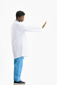 The doctor, in full height, on a white background, shows a stop sign.