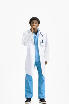 The doctor, in full height, on a white background, tells a secret.