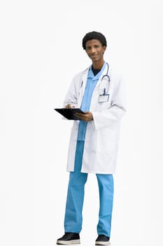 The doctor, in full height, on a white background, writes.