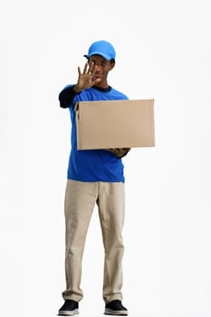 The deliveryman, in full height, on a white background, with a box, shows a stop sign.