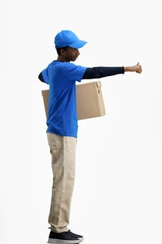 The deliveryman, in full height, on a white background, with a box, shows a thumbs up.