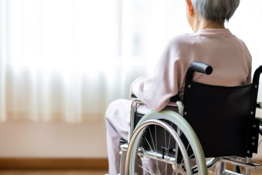 Rear view of an older patient sitting in wheelchair.