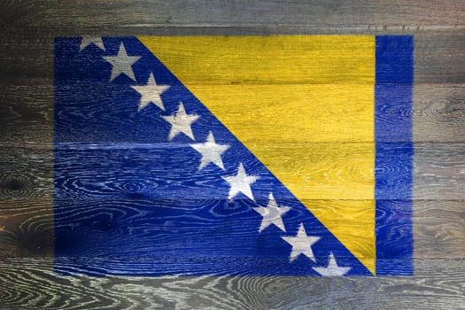 A Bosnia Herzegovina flag on rustic old wood surface background