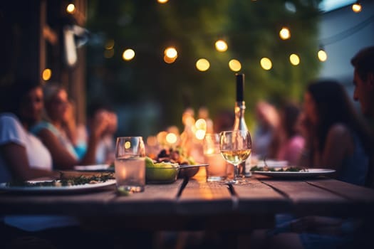 Happy friends having fun outdoor. Group of friends having backyard dinner party together.