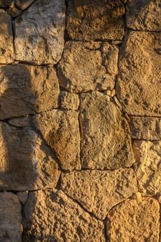 wall made of real stone as a background in the sun 3
