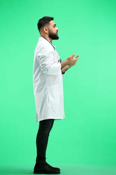 The doctor, in full height, on a green background, Gestures.