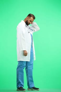 The doctor, in full height, on a green background, tired.