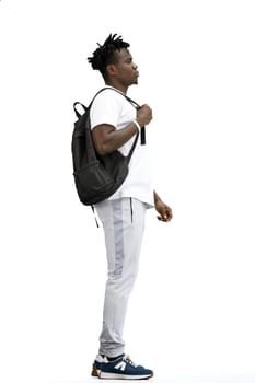 A man, full-length, on a white background, with a backpack.