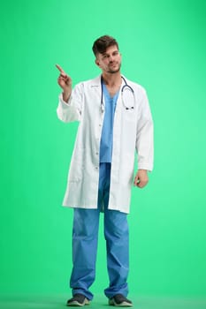 The doctor, in full height, on a green background, shows a stop sign.