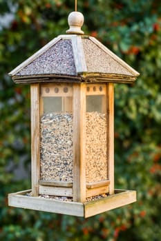 Bird house hanging from the tree.