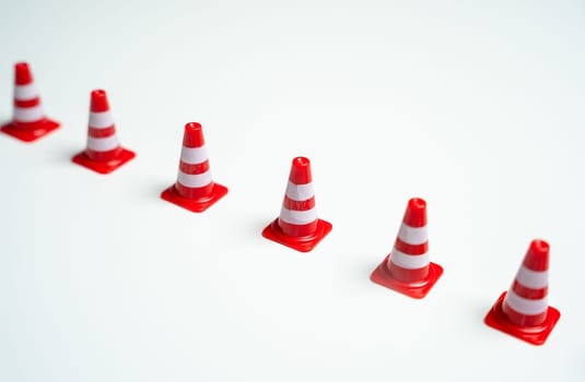 Road cones in a row. Barrier, fencing. Safety and red lines, red flags.
