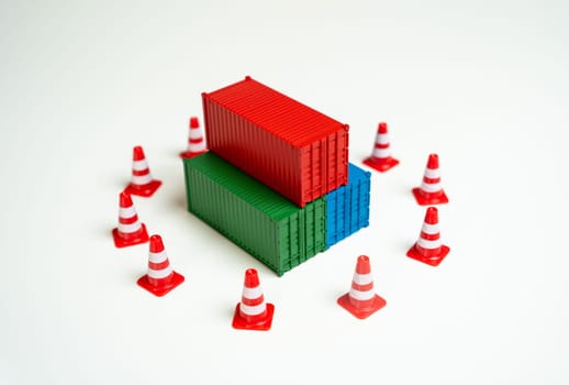 Seizure of cargo. Sea containers are surrounded by road cones and are inaccessible for transportation. Legal or logistical challenges hindering the movement of goods. Shipping complexities disruptions