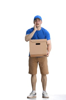 A male deliveryman, on a white background, full-length, with a box, tell a secret.