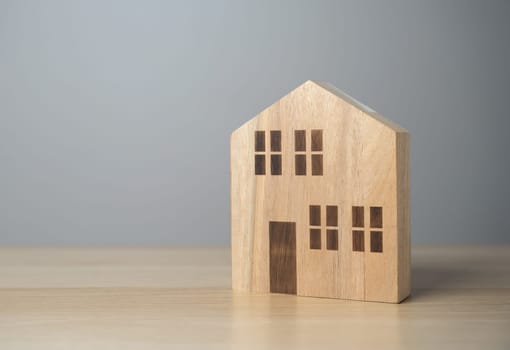 Wooden house figurine. Affordable housing. Buying a nice house. Garden work, landscape design. Figurine. Mortgage and loan.