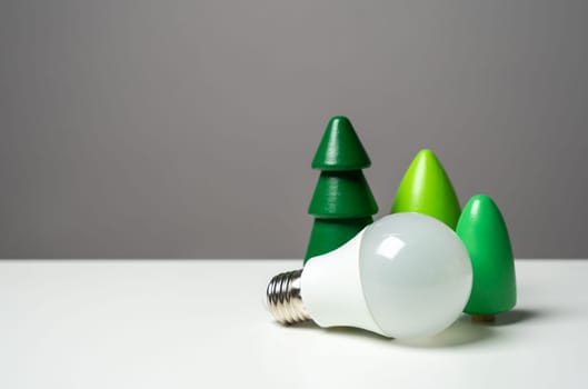 Economical LED light bulb and tree figurines. Energy savings, longevity, and environmental friendliness. Reduced carbon footprint. Connection to nature