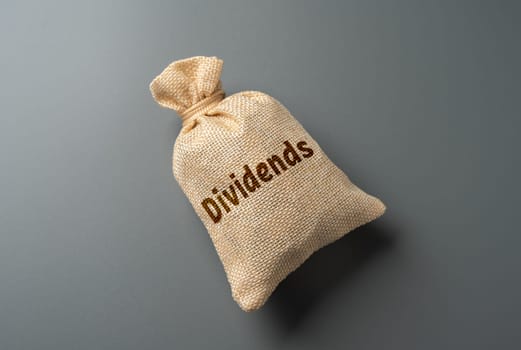 Bag with the word Dividends. Payment of dividends to officials. Maintain trust and financial integrity. Fair and equitable distribution