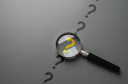 Magnifying glass and yellow question mark. FAQ. Solving mysteries, uncovering hidden truths. Curiosity, inquiry, uncertainty. Search for answers, clarity understanding. Quest for knowledge solutions