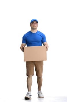 A male deliveryman, on a white background, full-length, with a box, puts a box.