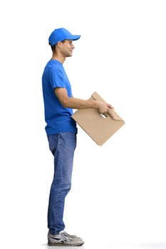 A male deliveryman, on a white background, full-length, with a box.