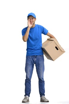 A male deliveryman, on a white background, full-length, with a box, tells a secret.